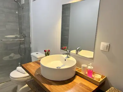 a bathroom with a sink and a toilet and a mirror at Refúgio do Ilhéu in Porto Moniz