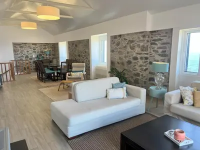a living room with a couch and a table at Refúgio do Ilhéu in Porto Moniz