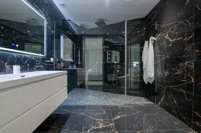 a black bathroom with a shower and a sink at Villa Pérola in Calheta