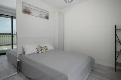 a blue couch in a living room with a map on the wall at OurMadeira - Vila Diana in Porto Santo
