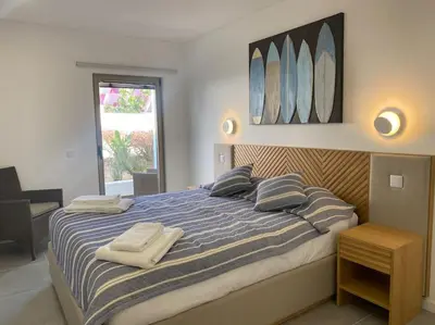 a bedroom with a large bed with two towels on it at Concha is a NEW apartment * 5min walk to the beach in Luz