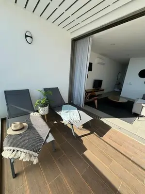 a living room with a glass table and chairs at Concha is a NEW apartment * 5min walk to the beach in Luz
