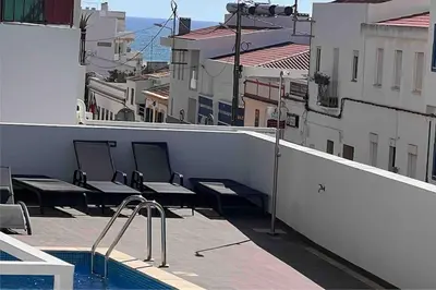 a balcony with benches and a swimming pool on a building at Concha is a NEW apartment * 5min walk to the beach in Luz