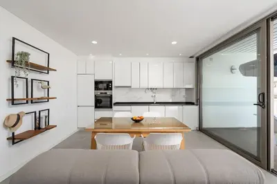 a kitchen with a table and chairs in a room at Concha is a NEW apartment * 5min walk to the beach in Luz