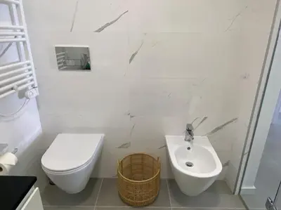 a white bathroom with a toilet and a sink at Concha is a NEW apartment * 5min walk to the beach in Luz