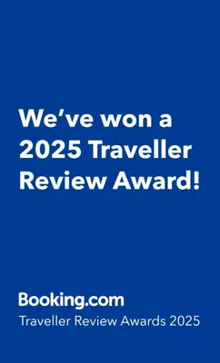 a blue sign that says weve won a traveler review award at Concha is a NEW apartment * 5min walk to the beach in Luz
