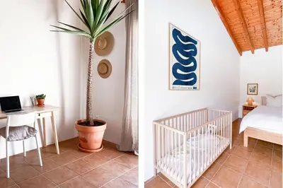 a bedroom with a bed and a desk and a palm tree at Casa de Pinheiro in Aljezur