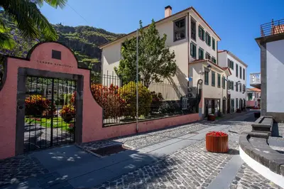 a cobblestone street with a gate and buildings at Visconde Apartment in Ribeira Brava