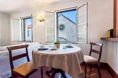 a dining room with a table and chairs and a window at Visconde Apartment in Ribeira Brava