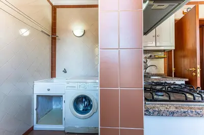 a kitchen with a washing machine and a stove at Visconde Apartment in Ribeira Brava