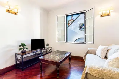 a living room with a couch and a coffee table at Visconde Apartment in Ribeira Brava