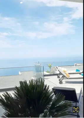 a view of the beach from a resort with a table and chairs at Villa Serenity in Prazeres