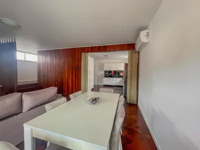 a living room with a white table and a couch at Villa Supranee Relaxation in Câmara de Lobos