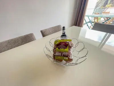 a bottle of alcohol sitting on a table at Villa Supranee Relaxation in Câmara de Lobos