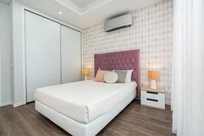 a bedroom with a bed and a wall with birds on it at Vincents Place I Ocean View I Swimming pool in Estreito da Calheta