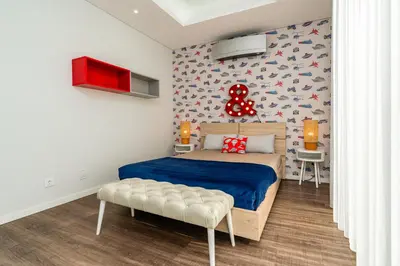 a bedroom with a bed and a balcony with grass at Vincents Place I Ocean View I Swimming pool in Estreito da Calheta