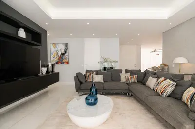 a living room with a couch and a television at Vincents Place I Ocean View I Swimming pool in Estreito da Calheta