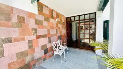 a brick wall with two chairs on a patio at Villa Vera Downtown in Funchal