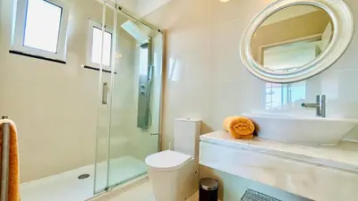 a bathroom with a toilet and a sink and a mirror at Villa Vera Downtown in Funchal