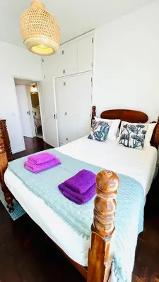 a bedroom with a bed with purple towels on it at Villa Vera Downtown in Funchal