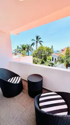 a balcony with two chairs and a view of the ocean at Villa Vera Downtown in Funchal