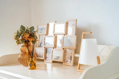 a vase with flowers on a table next to pictures at PAKISA - Three bedroom apartment in Funchal