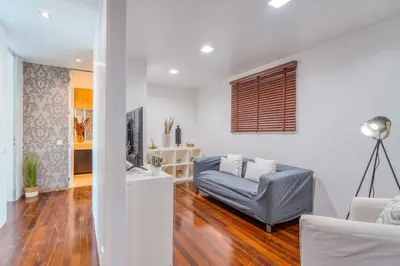 a living room with a couch and a television at PAKISA - Three bedroom apartment in Funchal