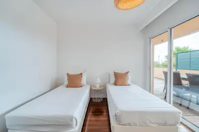 two beds in a room with a balcony at PAKISA - Three bedroom apartment in Funchal