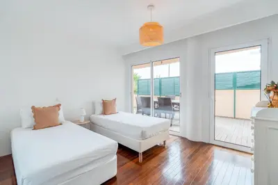 two beds in a room with a view of the ocean at PAKISA - Three bedroom apartment in Funchal
