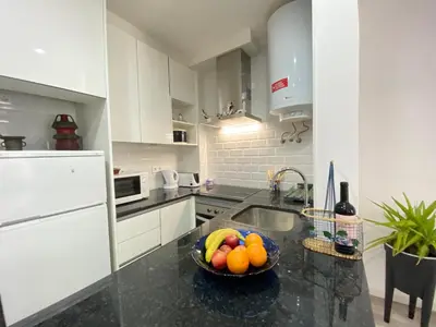 a kitchen with a bowl of fruit on a counter at NEW Luztur apartment 3min from Luz Beach in Luz