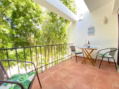 a balcony with chairs and a table on it at NEW Luztur apartment 3min from Luz Beach in Luz