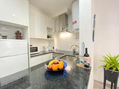 a kitchen with a bowl of fruit on a counter at NEW Luztur apartment 3min from Luz Beach in Luz