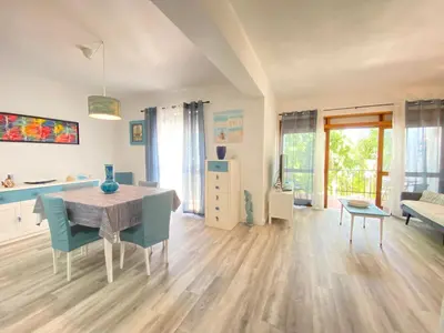 a living room with a dining room table and chairs at NEW Luztur apartment 3min from Luz Beach in Luz