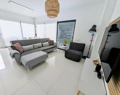 a living room with a couch and a chair at Apartamentos Aurea - Porto Santo in Porto Santo