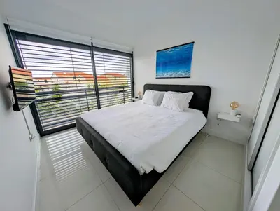a bedroom with a large bed and a window at Apartamentos Aurea - Porto Santo in Porto Santo