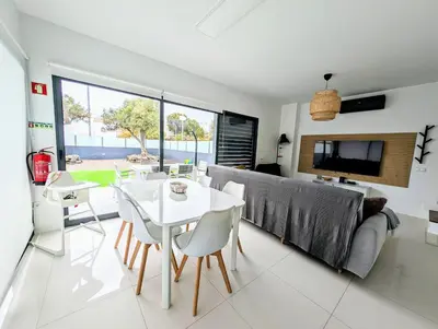 a living room with a table and a couch at Apartamentos Aurea - Porto Santo in Porto Santo