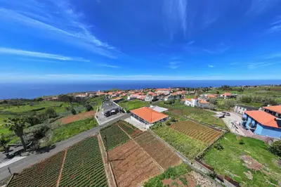 an aerial view of a village with houses and the ocean at Paul's Holiday House in Ponta do Pargo