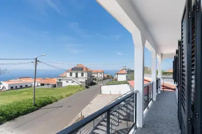a balcony with a view of the ocean at Paul's Holiday House in Ponta do Pargo