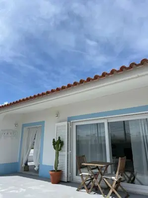 a patio with two chairs and a table on a house at Casa de Maio - New T2 - ARRIFANA BEACH 650 mts in Aljezur