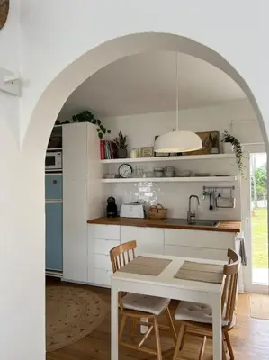 a kitchen with a table and chairs in a kitchen at Casa de Maio - New T2 - ARRIFANA BEACH 650 mts in Aljezur