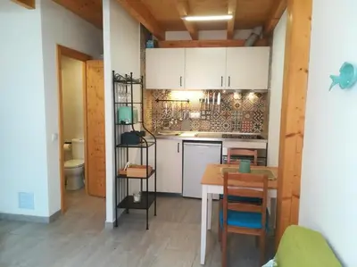 a kitchen with a table and a counter top at Studio Rufia in Vila do Bispo