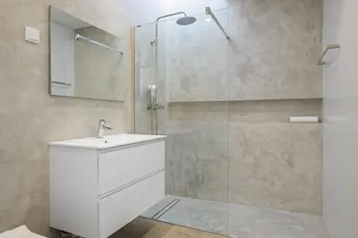 a bathroom with a shower with a sink and a mirror at Villa Elysian Oasis by Homie in Fajã da Ovelha
