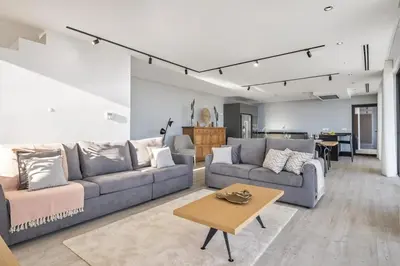 a living room with two couches and a table at Villa Elysian Oasis by Homie in Fajã da Ovelha