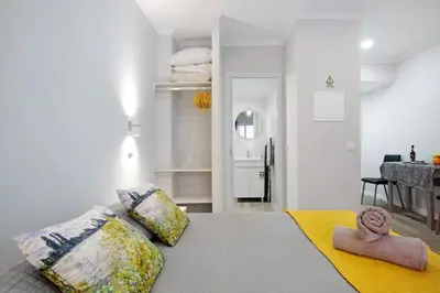 a bedroom with a bed with two pillows at Família Dória Nóbrega T0 in Funchal