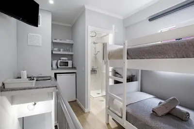 a room with a bunk bed with a towel at Família Dória Nóbrega T0 in Funchal