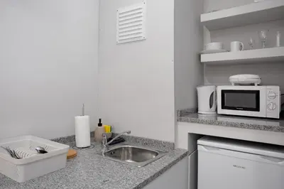 a kitchen with a sink and a microwave at Família Dória Nóbrega T0 in Funchal