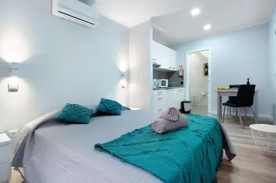 a bedroom with a large bed with towels on it at Família Dória Nóbrega Estúdio in Funchal