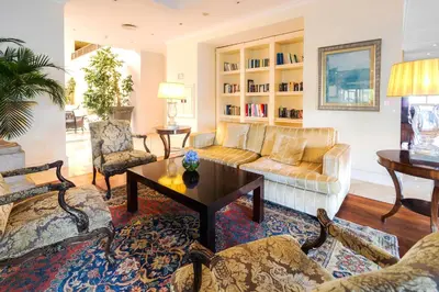 a living room with a couch and a table at Quinta Funchal Gardens - Adults Only in Funchal