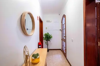 a small bedroom with a bed and a window at Casa do Neves in Funchal