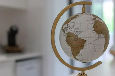 a golden globe on a stand in a room at gate15 in Machico